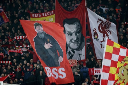 Liverpool fans at Anfield waving flags of Klopp and former manager Bob Paisley, during a match against Manchester United, January 2020.