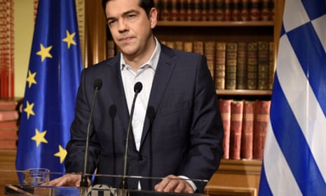Tsipras at a podium with Greek and Euro flags