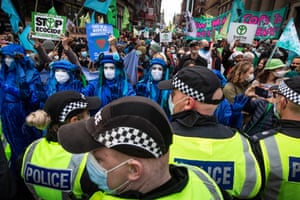 Police hold back demonstrators in central Glasgow on 3 November