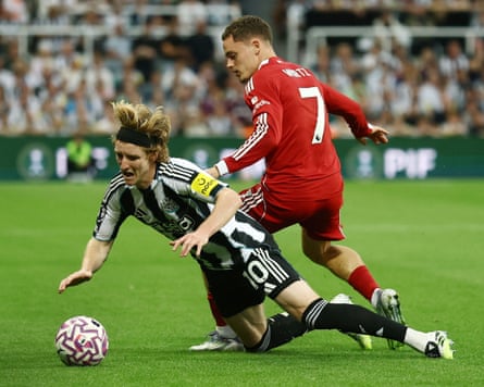 Newcastle’s Anthony Gordon is tackled by Liverpool’s Florian Wirtz