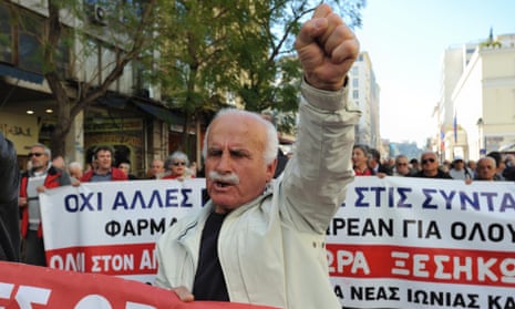 A pensioner raises his fist aloft as he marches in Athens shouting slogans against austerity cuts today.