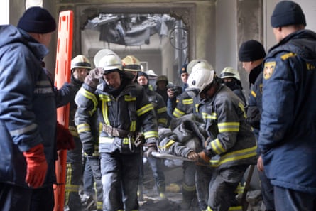 Emergency personnel carry a body out of the damaged local city hall of Kharkiv on March 1, destroyed as a result of Russian troop shelling