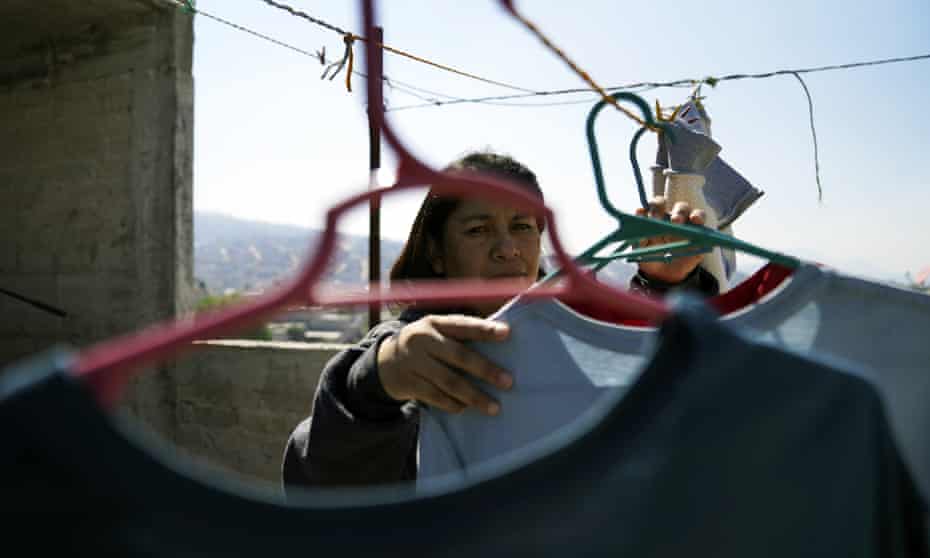 Marisol Garcia Alcantara hangs clothes to dry at her home in the municipality of La Paz, Mexico on Tuesday.