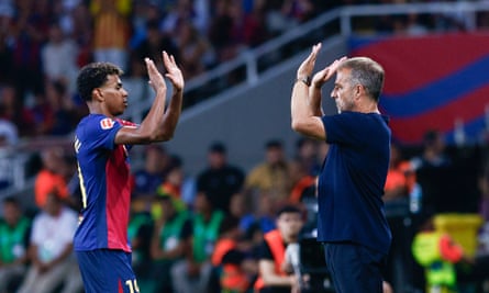 Hansi Flick high-fives Lamine Yamal during the victory against Athletic Bilbao