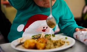 A child eating Christmas lunch at the Newcastle West End food bank.