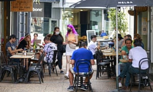 Customers eat outside in cafes in central Auckland, New Zealand, as the country is set to lead the world’s celebrations of the new year at midnight on Friday.