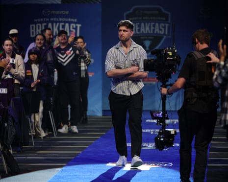 Jai Arrow receives a standing ovation as he arrives for the AFL grand final breakfast in Melbourne