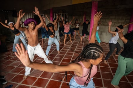 Young people practice traditional dances from the community. These musical styles and dances have their roots in African rhythms