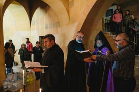 Archbishop Pargev Martirosyan during a night mass inside a shelter in Stepanakert