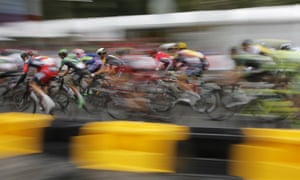 The cyclists blur along theChamps Elysees.
