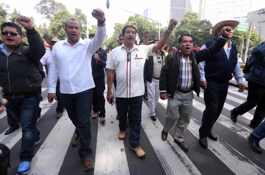 Francisco Manuel Villalobos (white shirt) and Ruben Nunez (white shirt holding red phone)