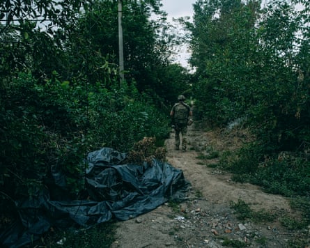 The body of a civilian covered with a plastic bag near the road to Kostyantynivka.