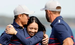 Team USA’s Collin Morikawa hugs partner Katherine Zhu on the 16th green after Team USA win the match during the Foursomes.