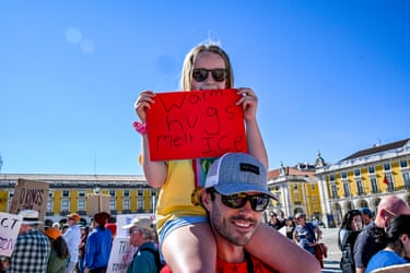 Lisbon, PortugalA girl holds a sign while sitting on her father’s shoulders as US nationals residing in Portugal gather in the Praça do Comercio.