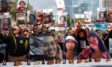 People holding up placards of Israeli hostages