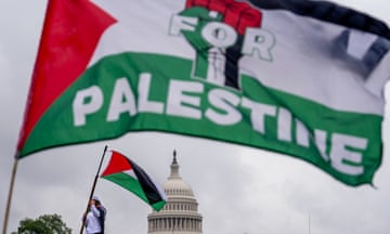 a person waves a Palestinian flag that says "freedom for Palestine"