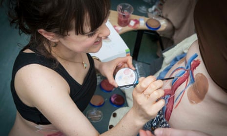 Trainee plastic surgeon Meg Anderson paints internal organs on body