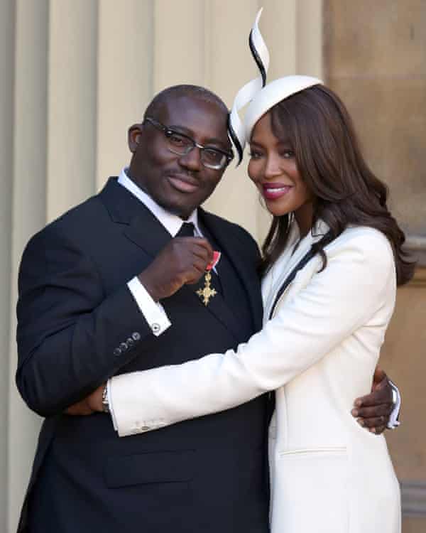 Enninful receiving his OBE with Naomi Campbell