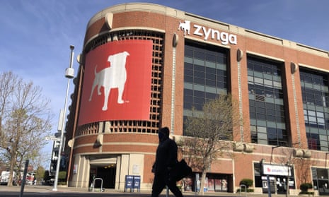 A pedestrian walks in front of a sign at Zynga in San Francisco.