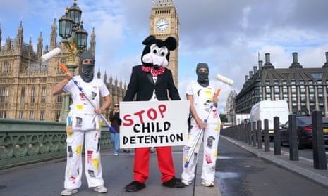 Comedian Dom Joly, dressed as Mickey Mouse, leading a Save the Children protest against the illegal migration bill on Westminster bridge today.