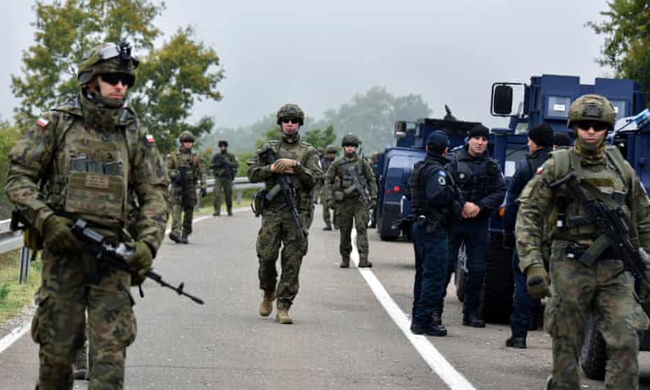 Members of the K-For peacekeeping force patrol the area near the border crossing between Kosovo and Serbia in Jarinje.