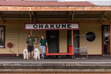 Janelle Finch and Austin Hobson outside Opus Fresh at the Ohakune railway station with their two samoyed dogs