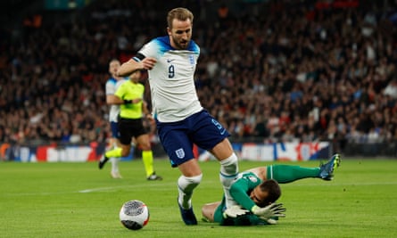 Harry Kane of England goes down under the challenge of the Malta goalkeeper Henry Bonello but isn’t given a penalty but is booked for diving.