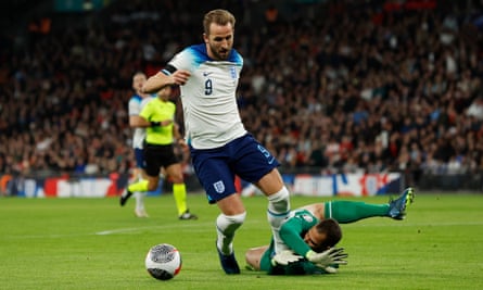 Harry Kane of England goes down under the challenge of the Malta goalkeeper Henry Bonello but isn't given a penalty but is booked for diving.
