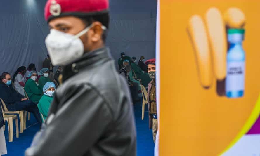 Medical workers wait to be vaccinated at a hospital in New Delhi