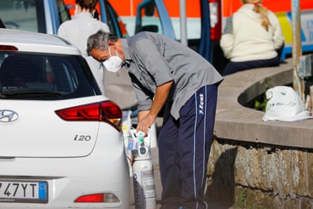A medic administers oxygen to a Covid-19 patient in their car at the Domenico Cotugno hospital in Naples, early November last year, as the facility had run out of space.