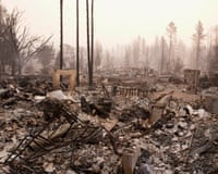 Smoky, ashy, barren landscape with a few burned trees.