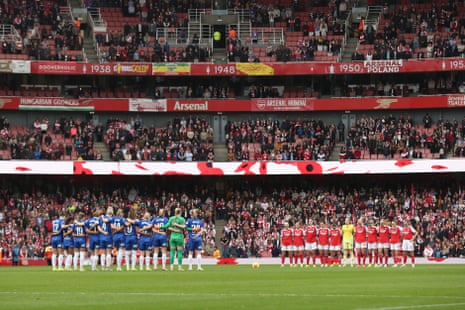 The players and fans observe a minute's silence ahead of kick-off during Arsenal v Chelsea Women's Super League match at the Emirates Stadium.