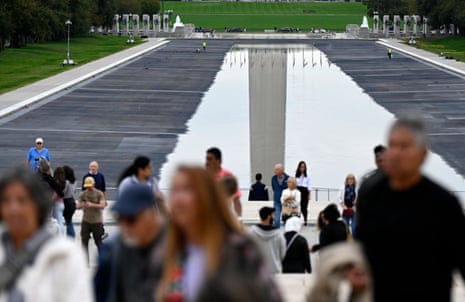 People walk past the reflecting pool