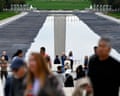 People walk past the reflecting pool