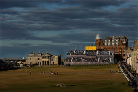Players walk up the 18th fairway with the clubhouse in the background during the 150th Open at St Andrews.