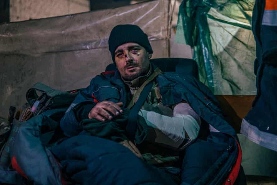 An injured Ukrainian work subordinate sits with his limb successful a sling wrong the Azovstal plant.
