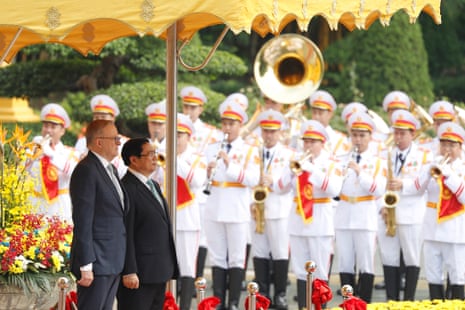 Vietnamese Prime Minister Pham Minh Chinh (R) and his Australian counterpart Anthony Albanese (L) review the guard of honor at the Presidential Palace in Hanoi.