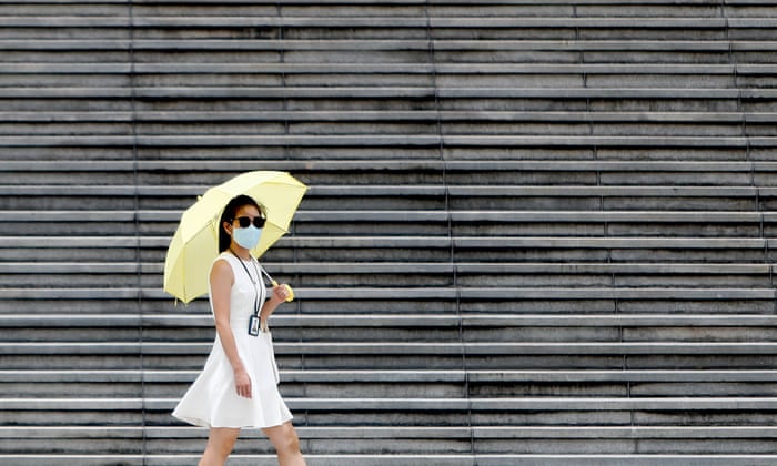 A woman wearing a face mask walks past at Liberty Square in Taipei, amid a domestic Covid-19 outbreak causing deaths and infections in Taiwan.