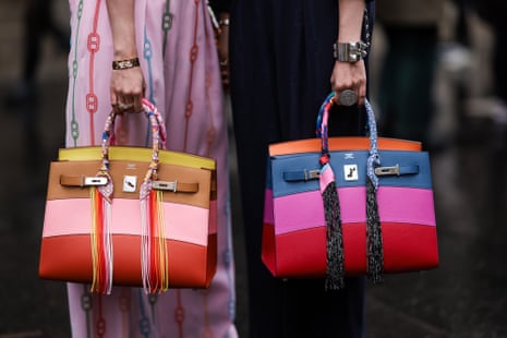 close up of colourful handbags held by two women