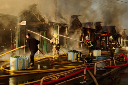 Firefighters work to put out a fire at a book market in Kyiv