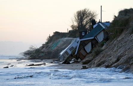 Collapsed houses lie on the beach after a storm surge in Hemsby, eastern England, in December 2013.