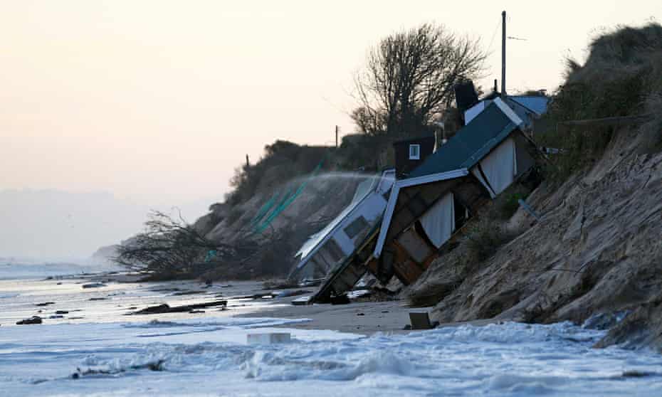 Collapsed houses lie on the beach after a storm surge in Hemsby, Norfolk, in 2013.