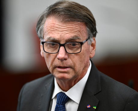 person wearing grey suit and glasses