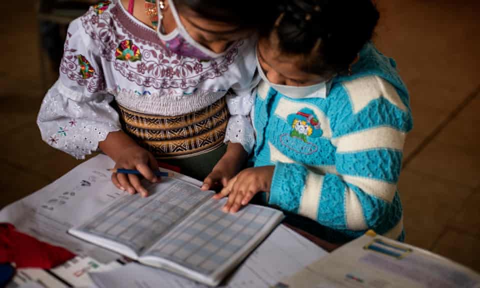 Two Karanki indigenous girls study together in San Clemente, Ecuador. 