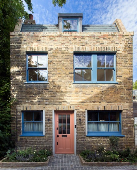 Brick house with blue window frames.