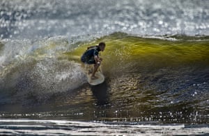 Michael Reinhardt surfs on Rockaway Beach