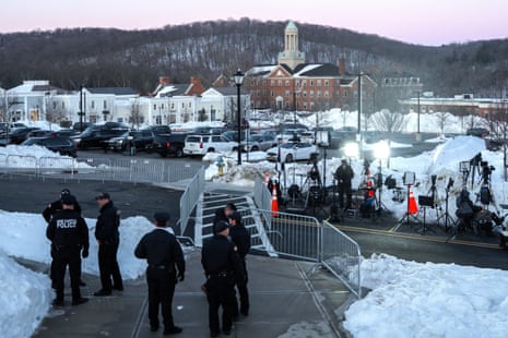 police and journalists stand outside
