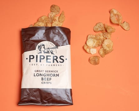 A packet of Pipers Longhorn beef crisps on an orange background.