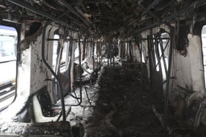 A subway car burnt by protesters is parked at the Elisa Correa station in Santiago