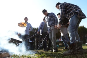 Residents make pancakes over a wood fire at Valennes, in north-west France